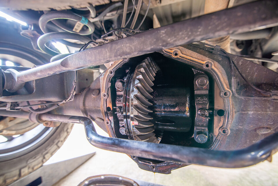 Close-up of a differential gear housing with oil residue during a repair
